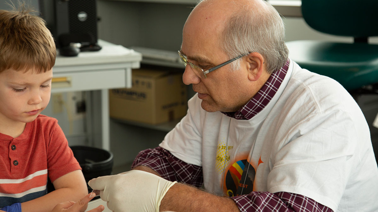 Dr Moore communicates with an attendee during a lab tour